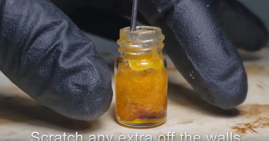 Scraping shatter from sides of vial to ensure that it decarbs evenly