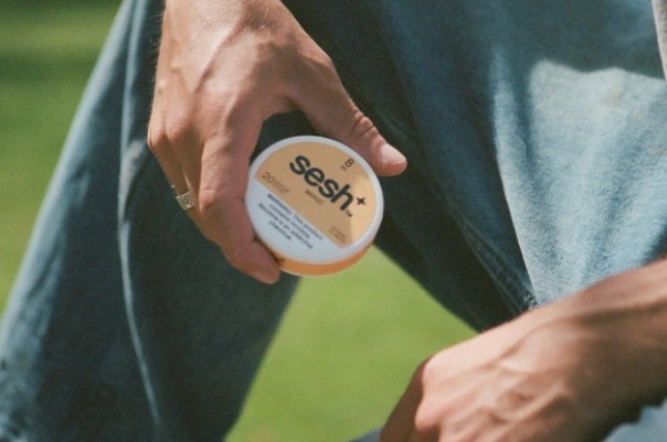 Are SESH+™ Mango Nicotine Pouches Worth It for Adult Nicotine Users? Man holding a SESH+™ mango nicotine pouch can.